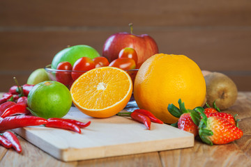 Healthy concept with mixed fruits and vegetables on wooden background