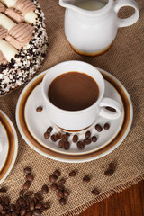 cups of coffee and milk and roasted coffee beans