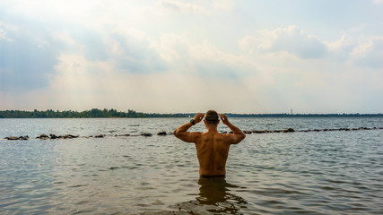 Man preparing for an openwater swim in a lake 