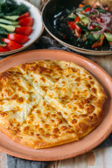 Traditional Georgian adjara khachapuri on the table. Homemade baking. khachapuri Kolkh and khachapuri at the Imereti.