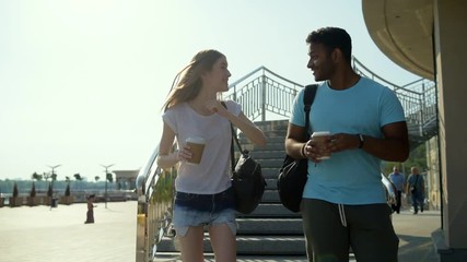 Amused smiling couple sharing emotions being outside