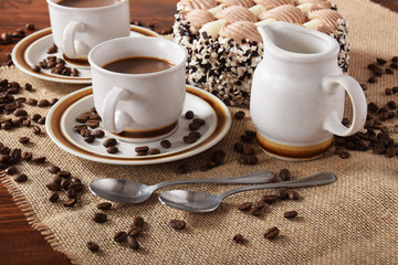 cups of coffee and milk and roasted coffee beans