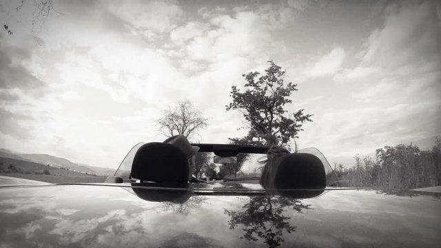 4K UHD TV resolution with grain B&W film emulation video of love couple travelling  in cabriolet car.