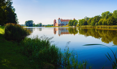 Medieval castle on the shore of the lake. Castle in Mir, Belarus - historical heritage of Belarus.