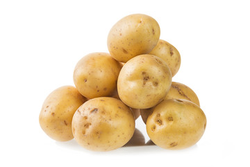 Heap of fresh young potatoes isolated on white background close up.
