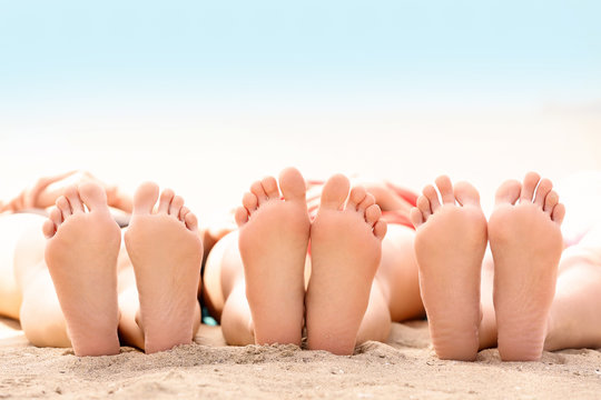 Beautiful young women lying in the sun on sea beach