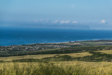 Fototapeta premium Looking down at Waimea town, the ocean, and the island of Ni'ihau, off in the distance, on Kauai