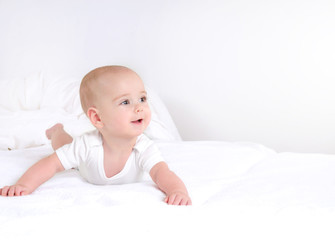 Infant child baby girl lying happy smiling on blanket