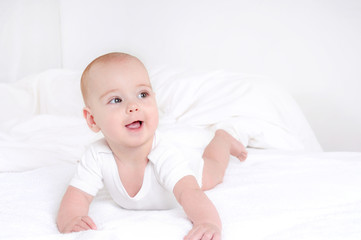 Infant child baby girl lying happy smiling on blanket
