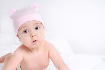 Close up picture of a cute little baby girl wearing at pink hat
