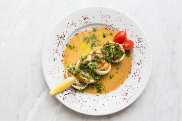 stuffed squid. Baked squid stuffed with onions, carrots and tmatoes.