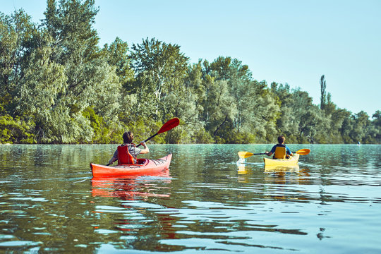 A canoe trip along the river along the forest in summer.