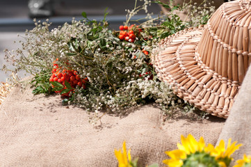 Rowan branches on burlap and straw hat