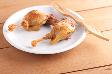 Fried duck leg on a white plate for a restaurant