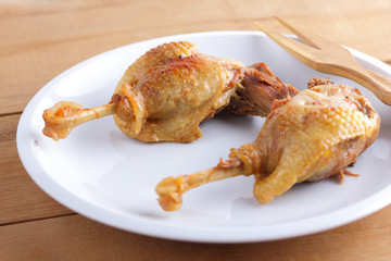 Fried duck leg on a white plate for a restaurant