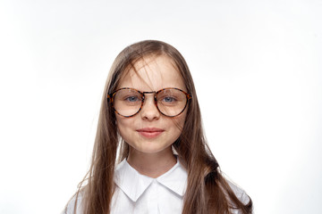 Fototapeta premium little girl with glasses on white isolated background, portrait