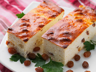 Russian cheesecakes with raisins on a white plate