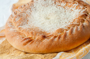 round pie with filling on a table