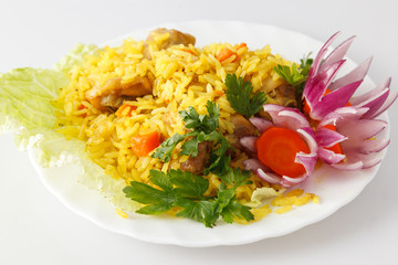 pilaf with meat on a white plate