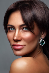 Portrait of young beautiful tanned woman with freckles