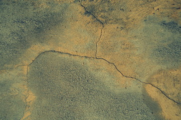 Cracked concrete wall covered with cement - background