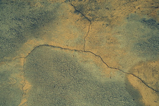 Cracked concrete wall covered with cement - background