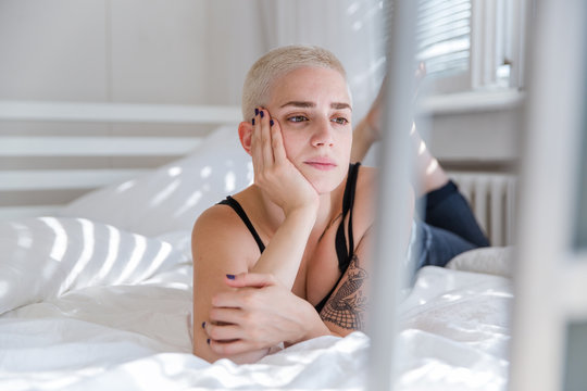 Portrait of a beautiful woman lying on bed