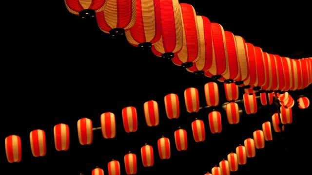 Paper red-white japanese lanterns Chochin shines on dark sky