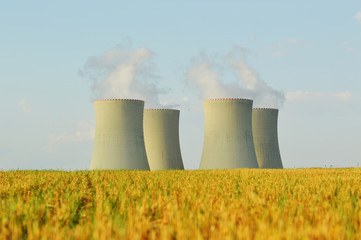 nuclear power plant, cooling towers and field and a car