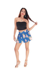 Tall beautiful woman is skirt standing