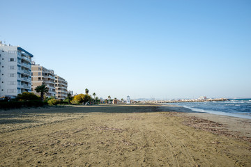 Fototapeta na wymiar Empty off season Kastela beach in Larnaca with MacKenzie Marina in background