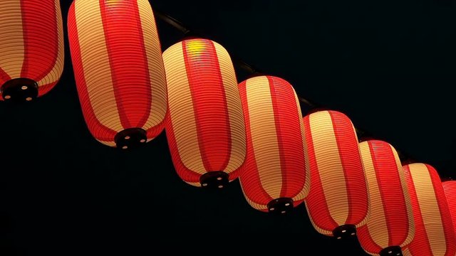 Paper red-white japanese lanterns Chochin shines on dark sky