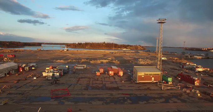 4K aerial view drone footage of Helsinki harbour area, boats, sheds and crans and urban city skyline view in the capital of Finland, northern Europe