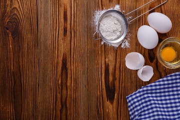 Baking background with eggshell. On wooden bakcgraund