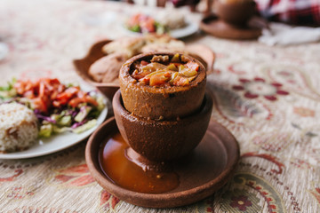 The national Turkish dish in the pot that is broken before use is called Testi-kebab. Restaurant with Turkish food.