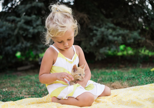 Child Playing with a Cat