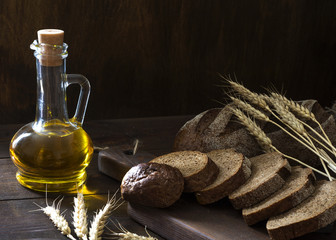 Vegetable oil and bread are on the table