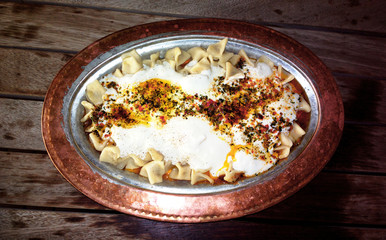 Traditional manti with garlic yogurt and red pepper sauce