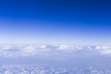 Fototapeta na wymiar clear blue sky background with white beautiful clouds. View from the window airplane. Travel concept