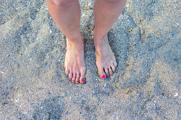 feet on the sand of a beach, summer relax vacation.
