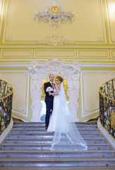 Fototapeta premium Wedding couple indoors is hugging each other