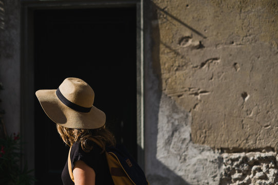 Woman walking with summer hat and sunshine