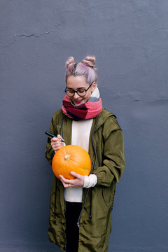 Girl drawing on pumpking