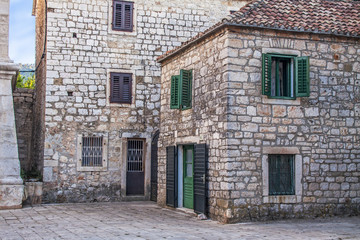 Fototapeta na wymiar Old Stone Houses on Square in Ancient Town Stari Grad in Croatian Island Hvar