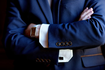 Handsome groom in suit in the hall
