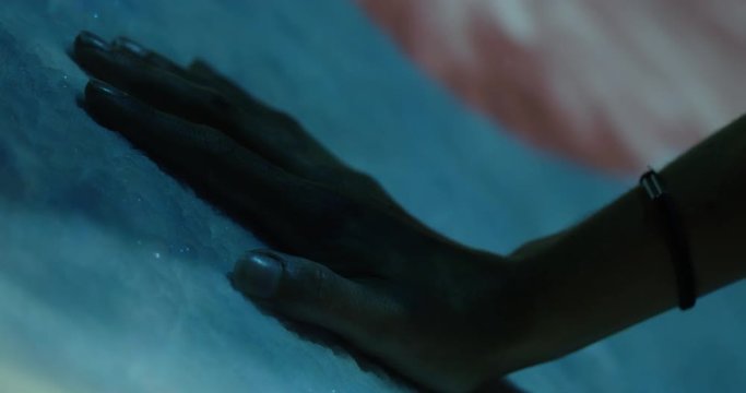 Women removes hand from ice with lightshow - cool exhibit