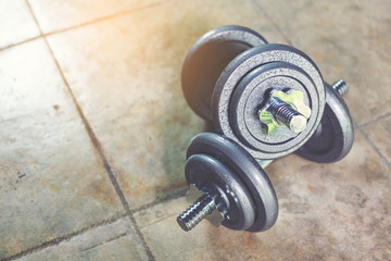 Naklejka na ściany i meble Twin Iron Dumbbells on the floor for home workout.