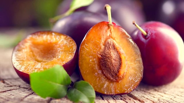 Plum. Ripe organic plums closeup on wooden table. 4K UHD video footage. Ultra high definition 3840X2160