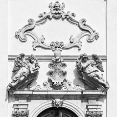 Fototapeta na wymiar Stone angels on the facade of a medieval church.