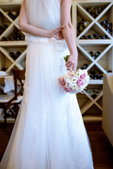 Beautiful bride is holding a wedding colorful bouquet